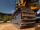 Close-up of a tracked excavator at a construction site.