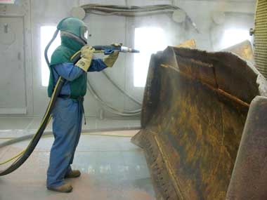 Sandblasting a bulldozer blade Sandblasting a bulldozer blade