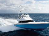 Sportfishing boat traveling at high speed across open water.
