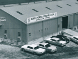 Historic aerial view of the original Ring Power Corporation facility with vehicles parked outside.