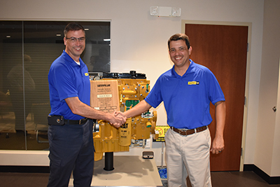 Devin Rawn receives his Caterpillar Instructor Accreditation certificate from Abel Posada.
